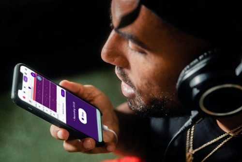 man recording music on an iphone